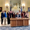 2)	Governor Kevin Stitt is surrounded by supporters as he signs Senate Bill 17 into law on Wednesday, August 4, 2021.